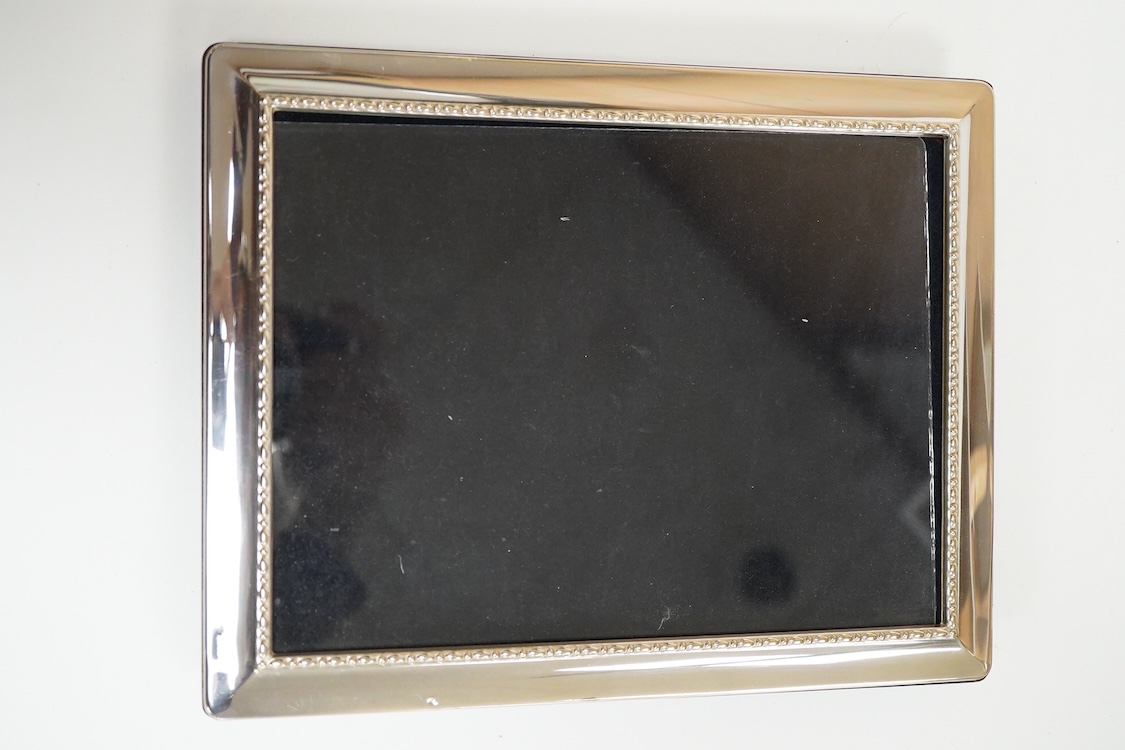 A pair of modern silver mounted photograph frames, 20.8cm and matching larger frame, 23.2cm, by Carr's of Sheffield, Ltd, Sheffield, 1996, together with one other modern silver mounted photograph frame and a similar Ital